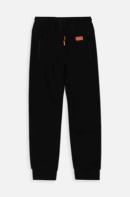 Zdjęcie produktu Coccodrillo spodnie dresowe bawełniane dziecięce kolor czarny gładkie