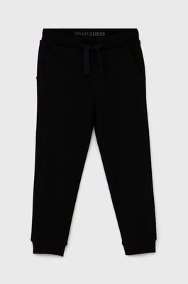 Zdjęcie produktu Guess Spodnie dziecięce kolor czarny gładkie