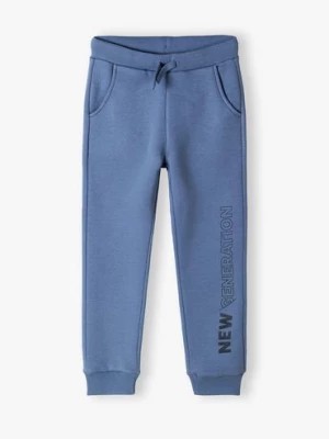 Zdjęcie produktu Spodnie dresowe niebieskie z napisem na nogawce- New generation Lincoln & Sharks by 5.10.15.